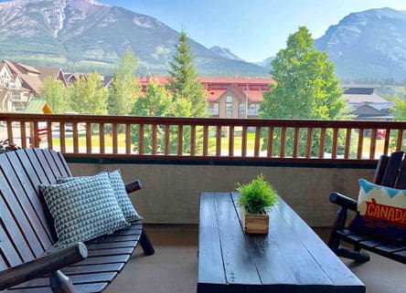Balcony with mountain view and patio furniture.