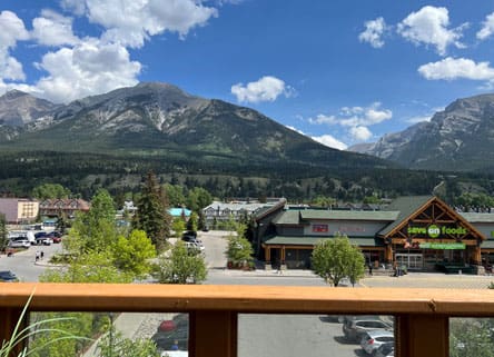 Mountain view with grocery store and cars.